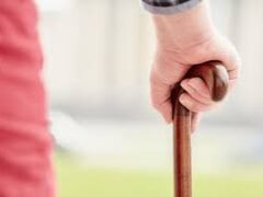 Closeup of a hand on a walking cane